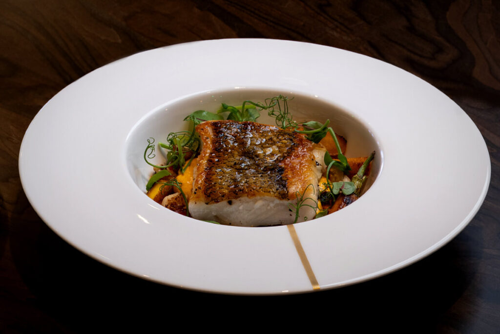 Chilean Seabass made with burst vine tomato cauliflower carrots and a delicious curry Hollandaise